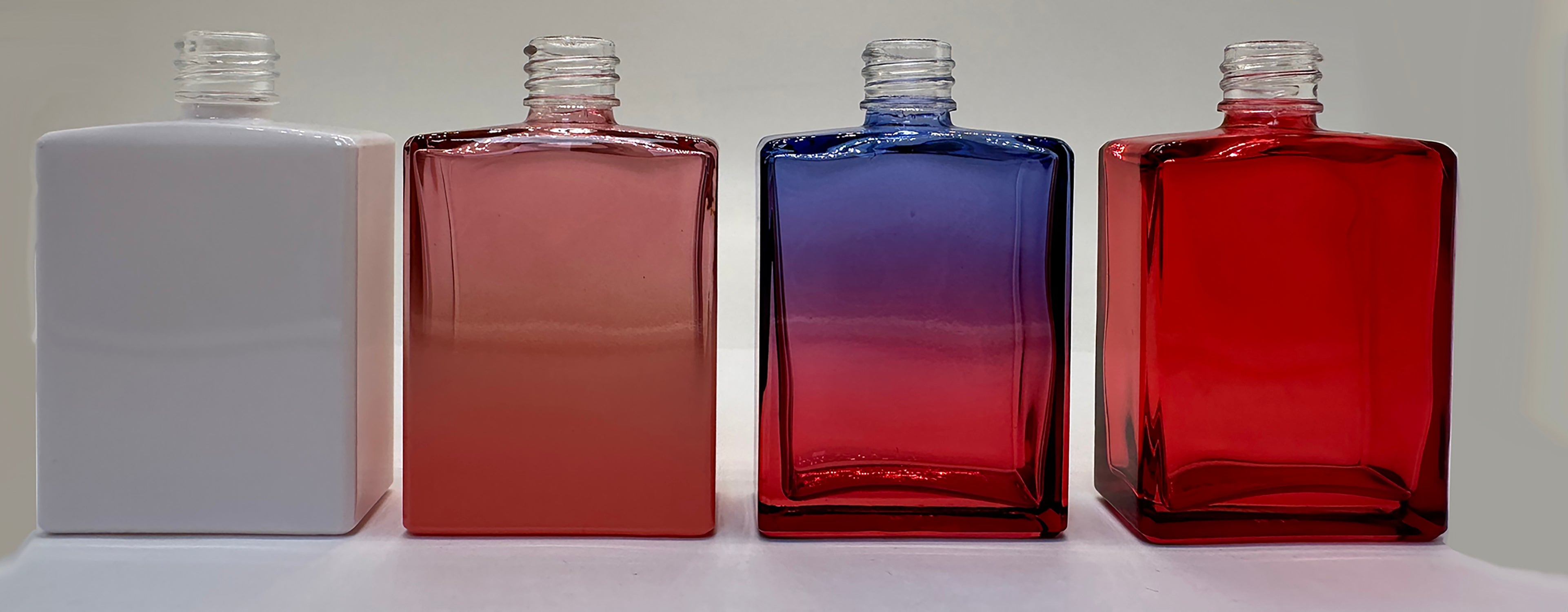 Rectangular bottles with white and metallic decorative finishes